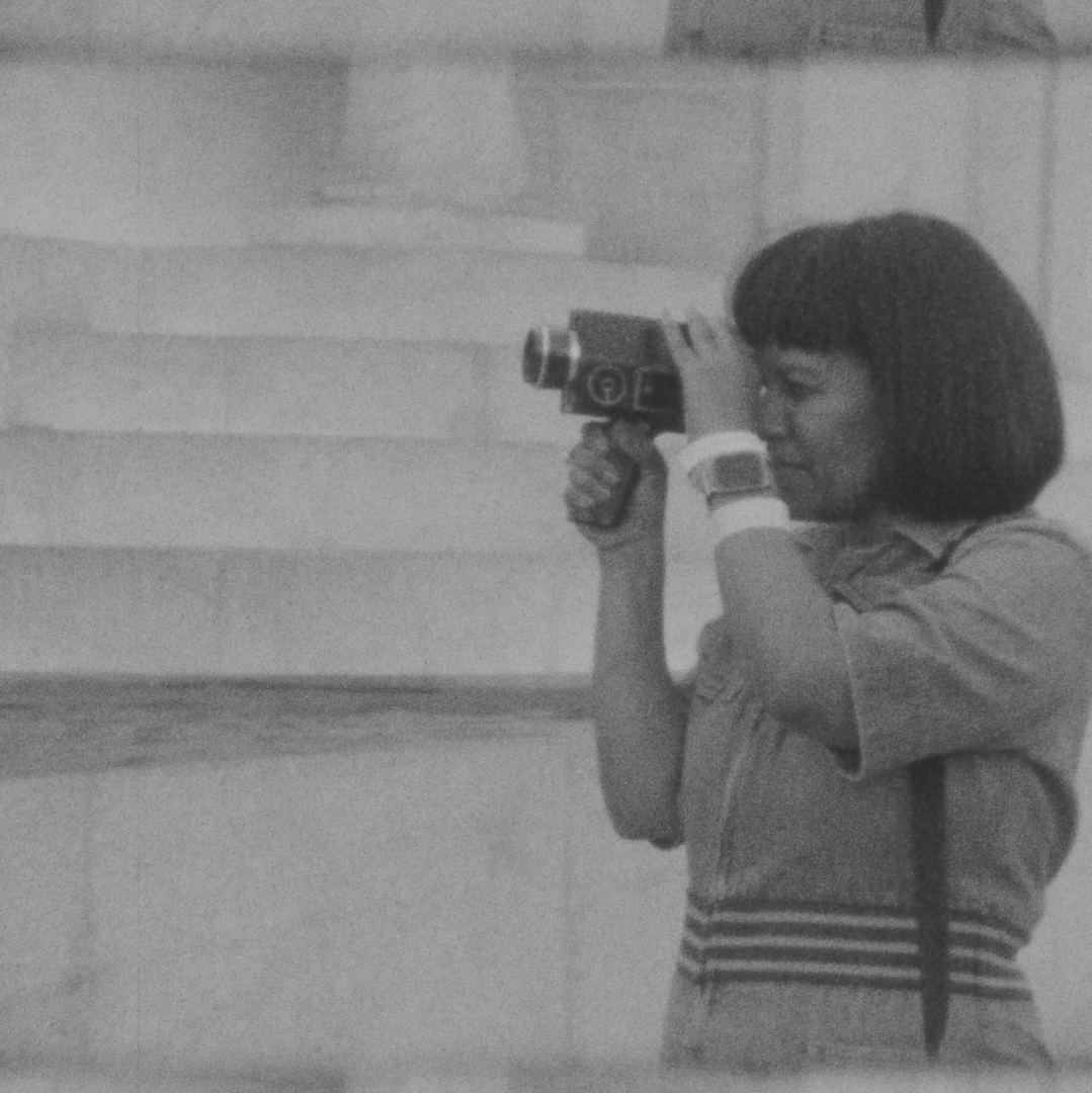 Nesanet holds a camera