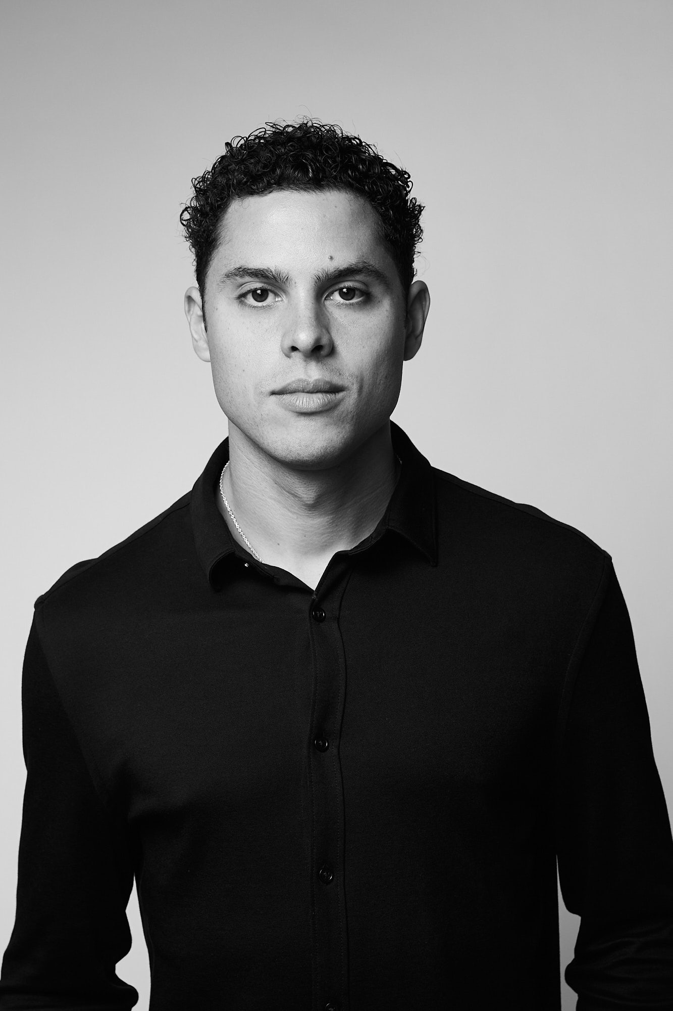 black and white photograph of a man in a black shirt 