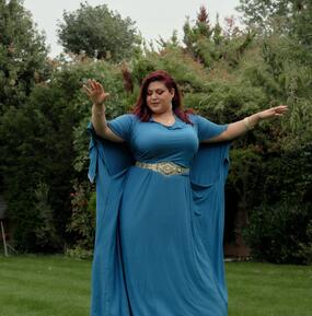 Esraa in blue dress in the grass
