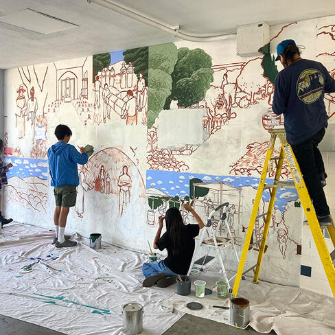 artists paint a mural