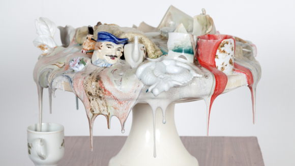 A cake stand covered in melted figurines and glassware