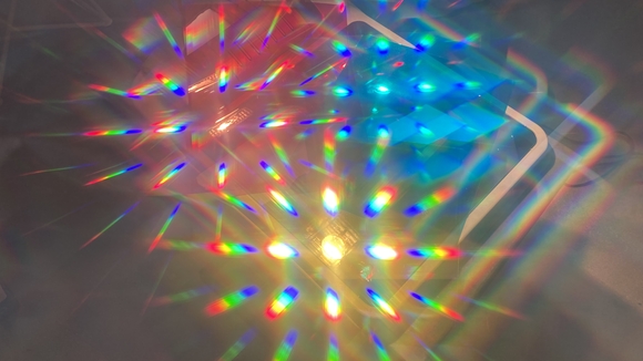 Prisms refracting yellow, blue and red light in an abstract pattern 