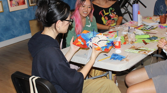 An artist holds the book she has made