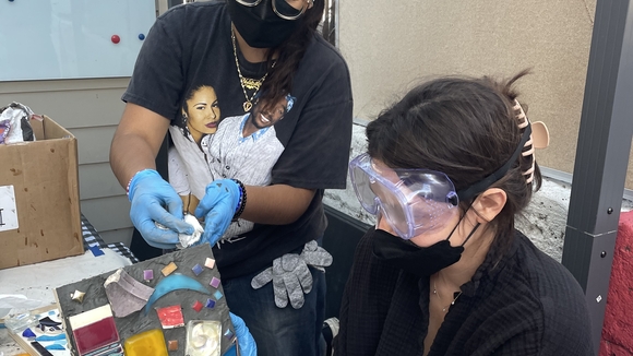 artist displaying finished mosaic