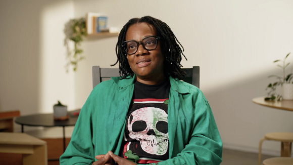 Cauleen Smith in a green blazer speaking to camera