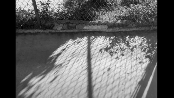 Black and white photo of a wall with a shadow by Nica Aquino