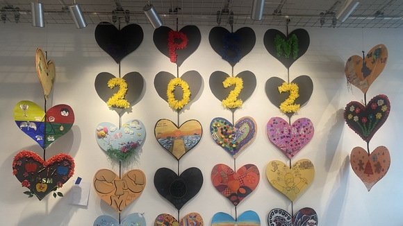 Decorated paper hearts hung vertically with 2022 written across the center.