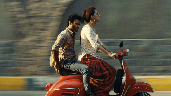 Two people on a red motorcycle