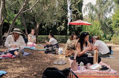 wide color photo of people doing crafts in a garden