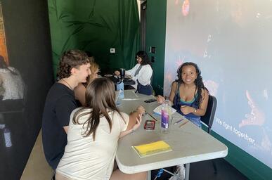 color image of four people creating books at an arts workshop