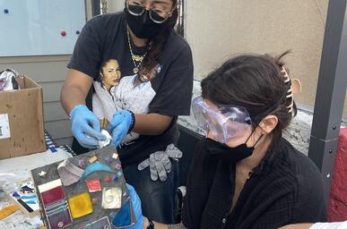 color image of a workshop participant making a mosaic