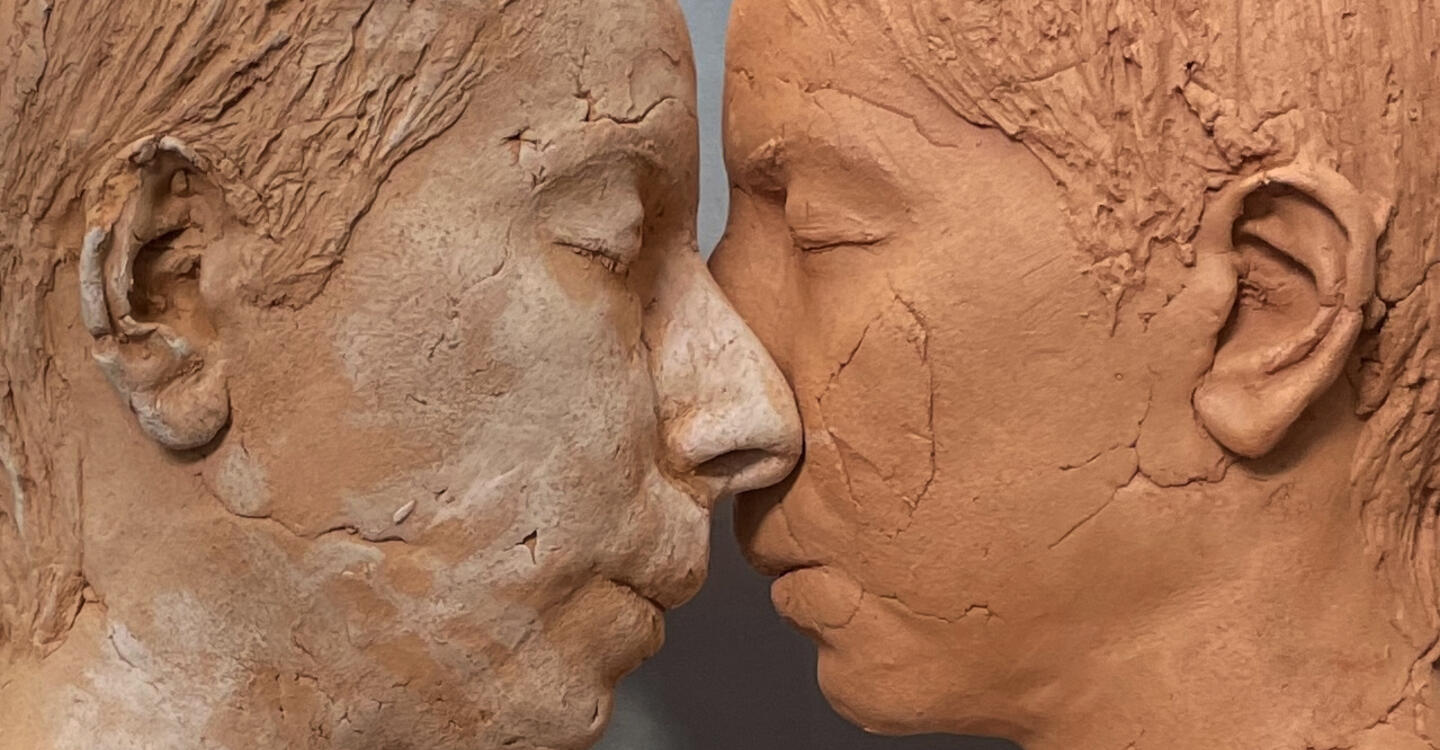 color photo of two sculptural faces by Roskana Pirouzmand, facing each other so their noses touch