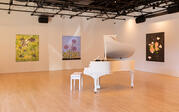 Exhibition Image of "EJ Hill: Wherever we will to root" that features a piano and three floral paintings