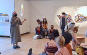 Kris speaking to a group of people in the gallery