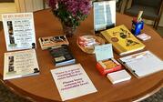 Table display of flyers about the OXY Arts Speaker Series