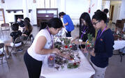 students standing around table and potting plants