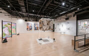 Gallery shot depicting the cube, paintings, and folding panel