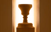 rectangular inset box housing a wooden Rubin face vase illuminated from behind with a white light