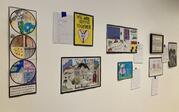 Gallery shot of multiple drawings and artworks