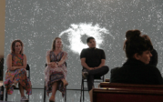 A group view of panel Prof. Mariška Bolyanatz Brown, Sasha Sherman, Prof. Amanda Tasse, and Jonathan Yomayuza listening to an audience member ask a question.