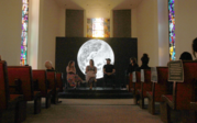 A group view of panel Prof. Mariška Bolyanatz Brown, Sasha Sherman, Prof. Amanda Tasse, and Jonathan Yomayuza with Last Whispers behind them.