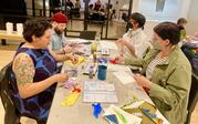 People making art with textiles and watercolor.