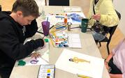 People making art with textiles and watercolor.