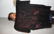 Artist holds up his bleach dye t-shirt.