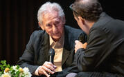 medium shot of Ed Ruscha looking at Paul Holdengraber