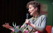 profile medium shot Miranda July speaking to audience
