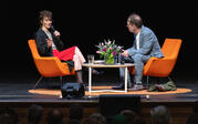 full shot Miranda July and Paul Holdengraber on stage