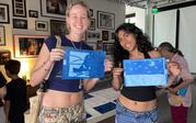 Cyanotype Drawing Workshop - artists holding up artwork
