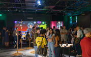 Landscape shot of guests socializing at opening reception