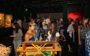 People socializing watching Reuben Telushkin's "Free the Land" moving