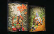 Hanging from ceiling, 2 of Johnathan Barber's large oil pastel portraits of Black male figures with unicorn heads in foliage, with various pop-culture iconography.