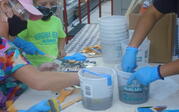 People applying grout to ceramic surfaces