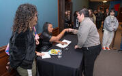 Robin Coste Lewis fistbumps an excited reader at the book signing.