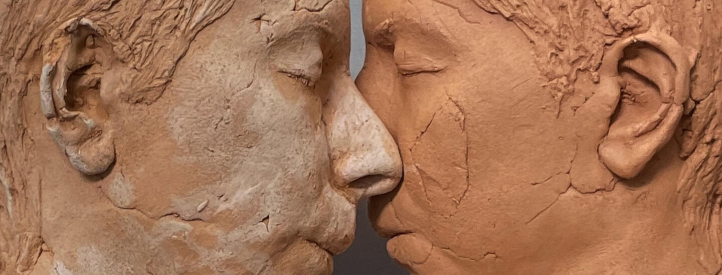 color photo of two sculptural faces by Roskana Pirouzmand, facing each other so their noses touch