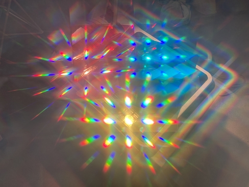 Prisms refracting yellow, blue and red light in an abstract pattern 