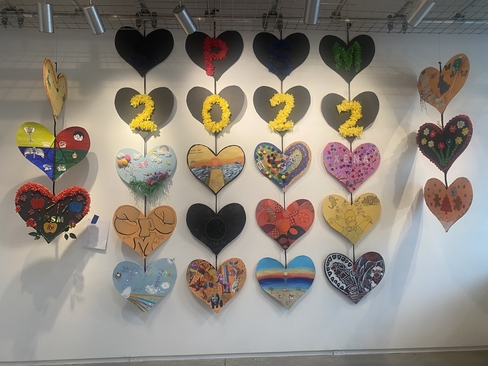 Decorated paper hearts hung vertically with 2022 written across the center.