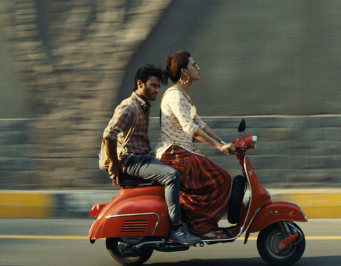 Two people on a red motorcycle