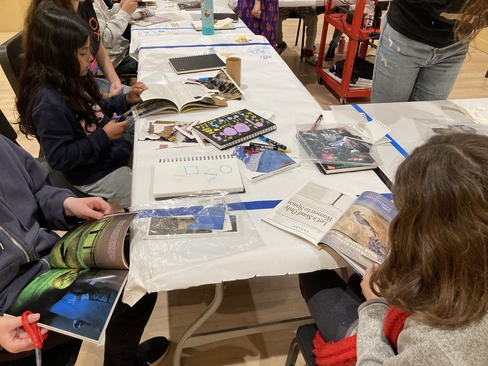 Students collaging at a table together