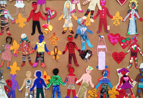 Colorful picture of children's artwork depicting different figures in brightly colored outfits. 