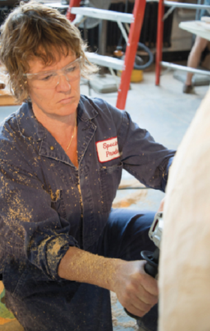 Jessica Rath chain-sawing basswood for sculpture titled "Resonant Nest". 