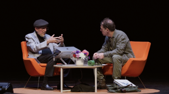 wide full-color shot of Kip Thorne & Paul Holdengräber on stage